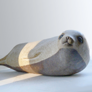 The Antarctic Seal was designed by Weston and Brenda Andersen. This is the only known Antarctic Seal produced in this gentle brown finish. The Antarctic Seal is slip-cast in red stoneware, brushed with the brown slip designed by Weston, and the waxed before being glazed in the white glaze designed by Weston to create a soft and alluring effect, The Antarctic Seal is 17 inches long