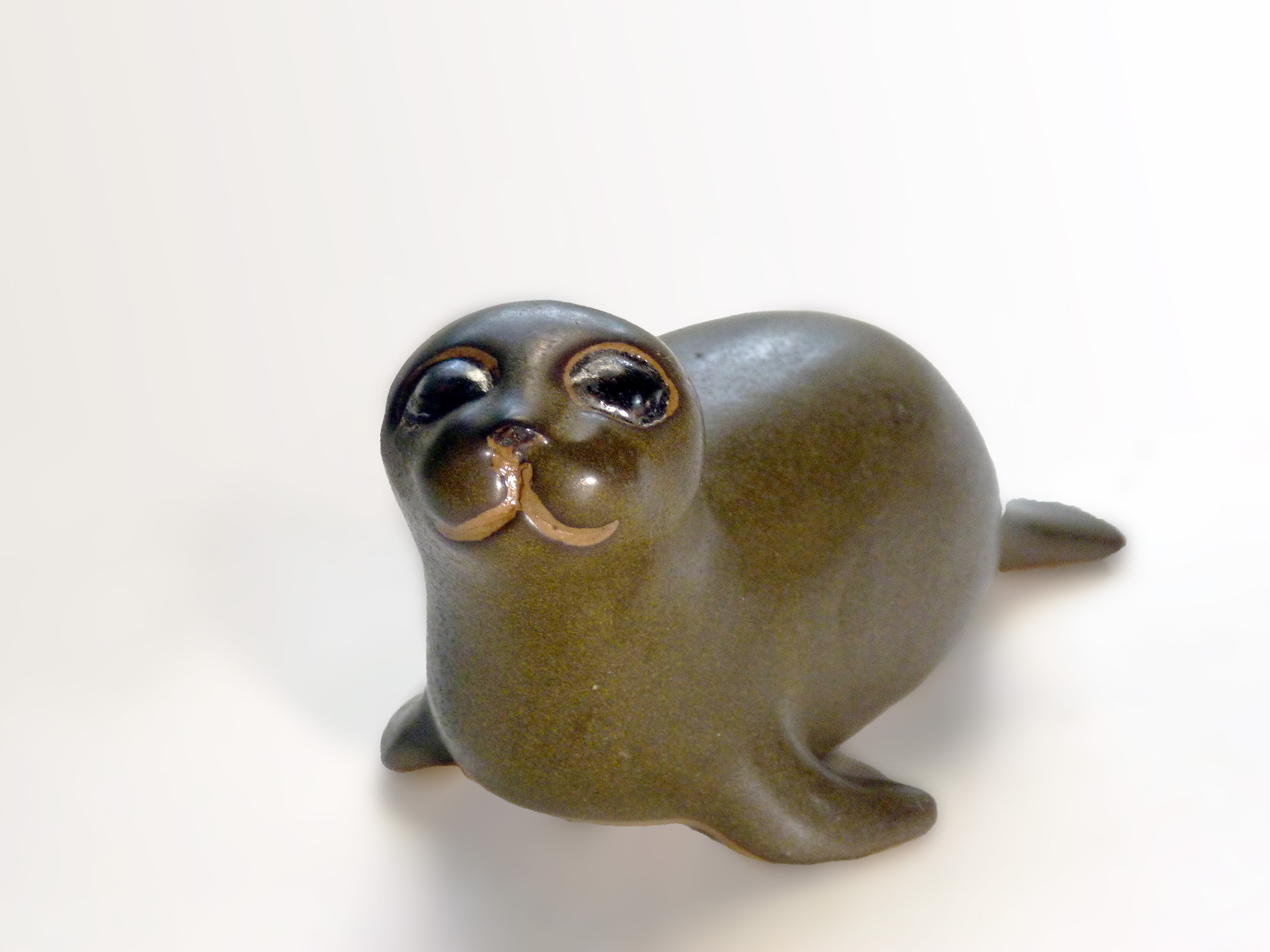 Vintage Baby Seal Early designed by Weston and Brenda Andersen is the early version with wide eyes and short nose., Glazed in rare vintage brown glaze designed by Weston. Eyes ebony. Slip cast in red body. All handcrafted in America, 7 inches long