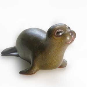 Vintage Baby Seal Early designed by Weston and Brenda Andersen is the early version with wide eyes and short nose., Glazed in rare vintage brown glaze designed by Weston. Eyes ebony. Slip cast in red body. All handcrafted in America, 7 inches long