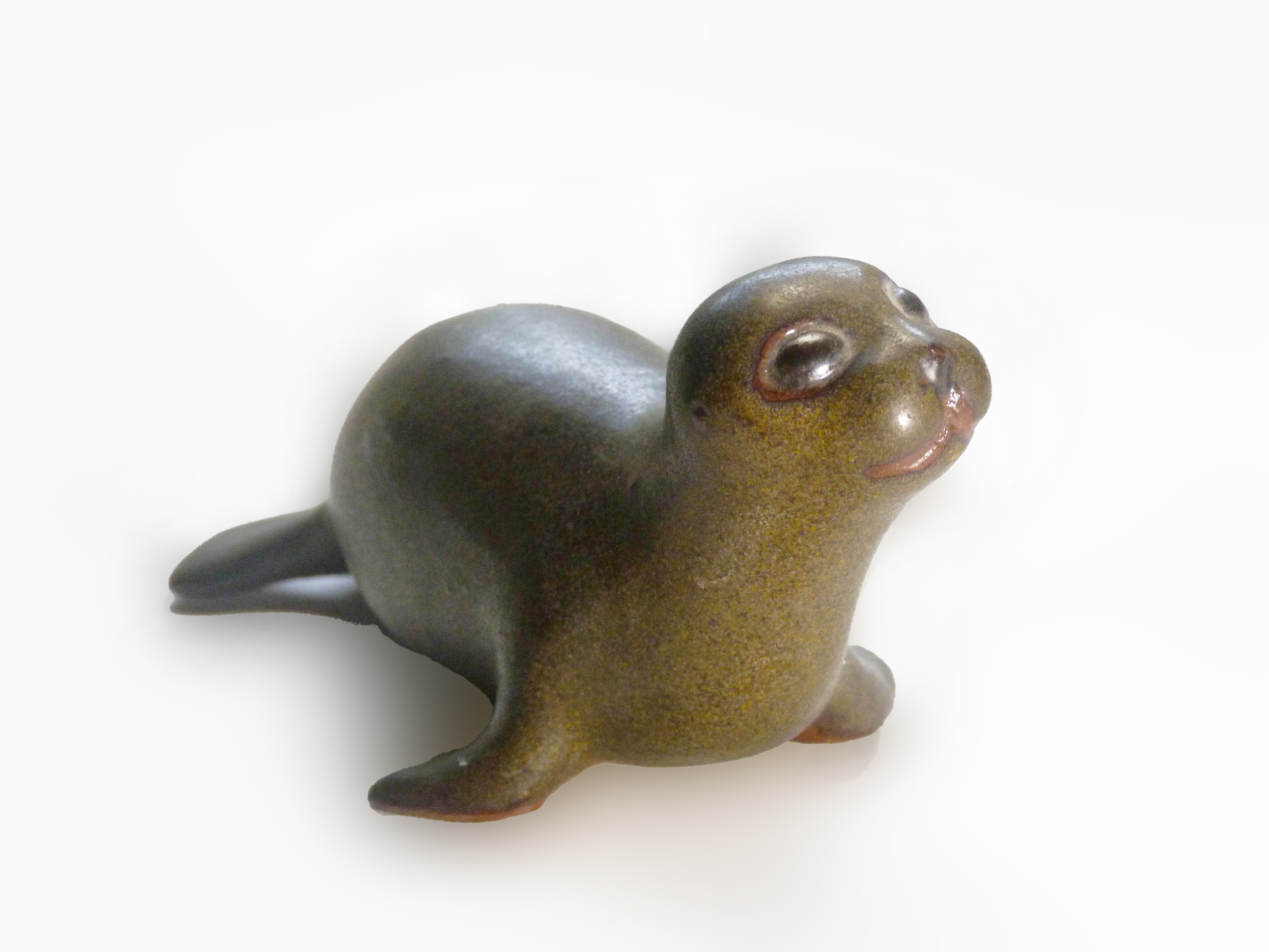 Vintage Baby Seal Early designed by Weston and Brenda Andersen is the early version with wide eyes and short nose., Glazed in rare vintage brown glaze designed by Weston. Eyes ebony. Slip cast in red body. All handcrafted in America, 7 inches long