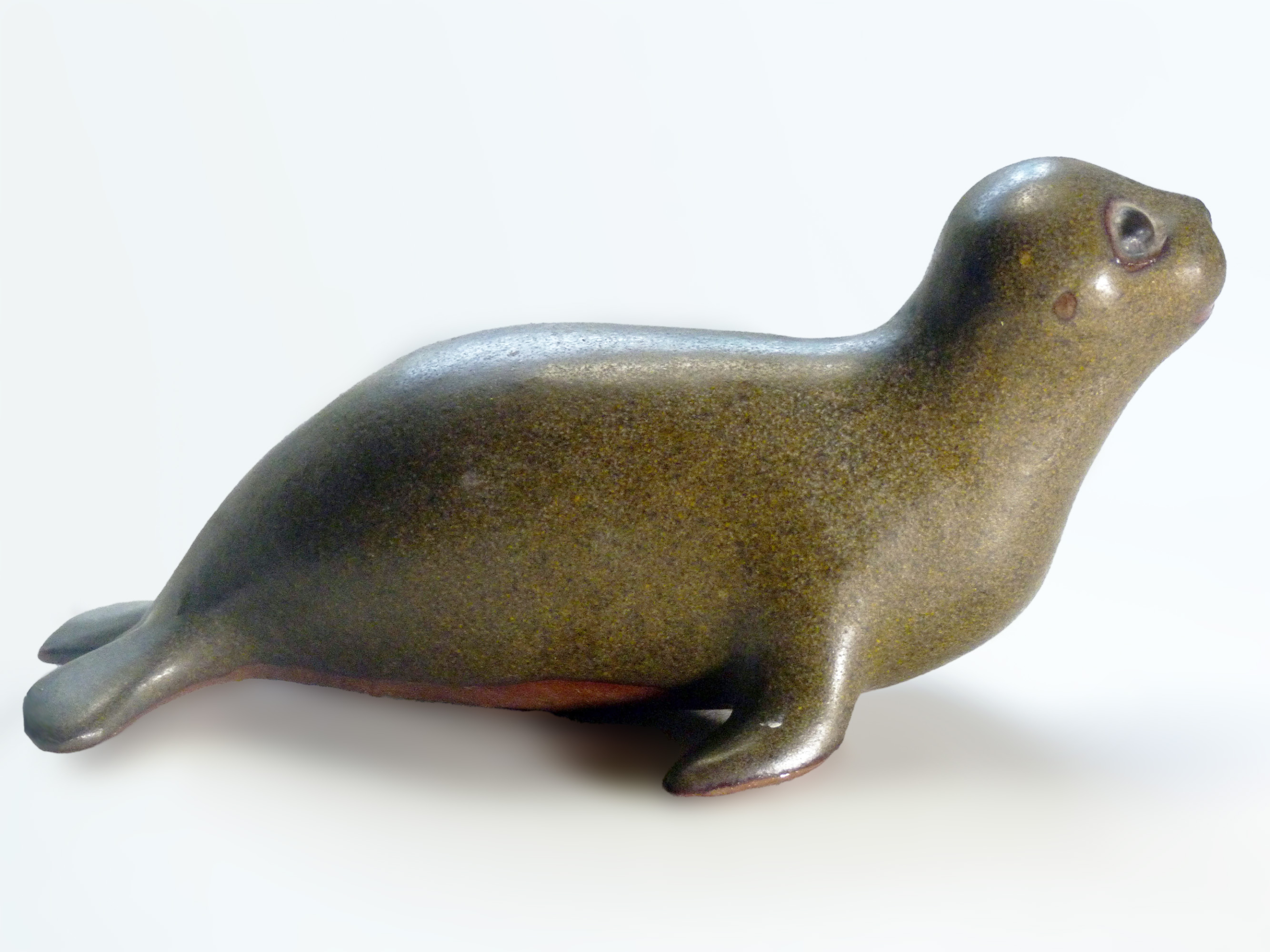 Vintage Baby Seal Early designed by Weston and Brenda Andersen is the early version with wide eyes and short nose., Glazed in rare vintage brown glaze designed by Weston. Eyes ebony. Slip cast in red body. All handcrafted in America, 7 inches long
