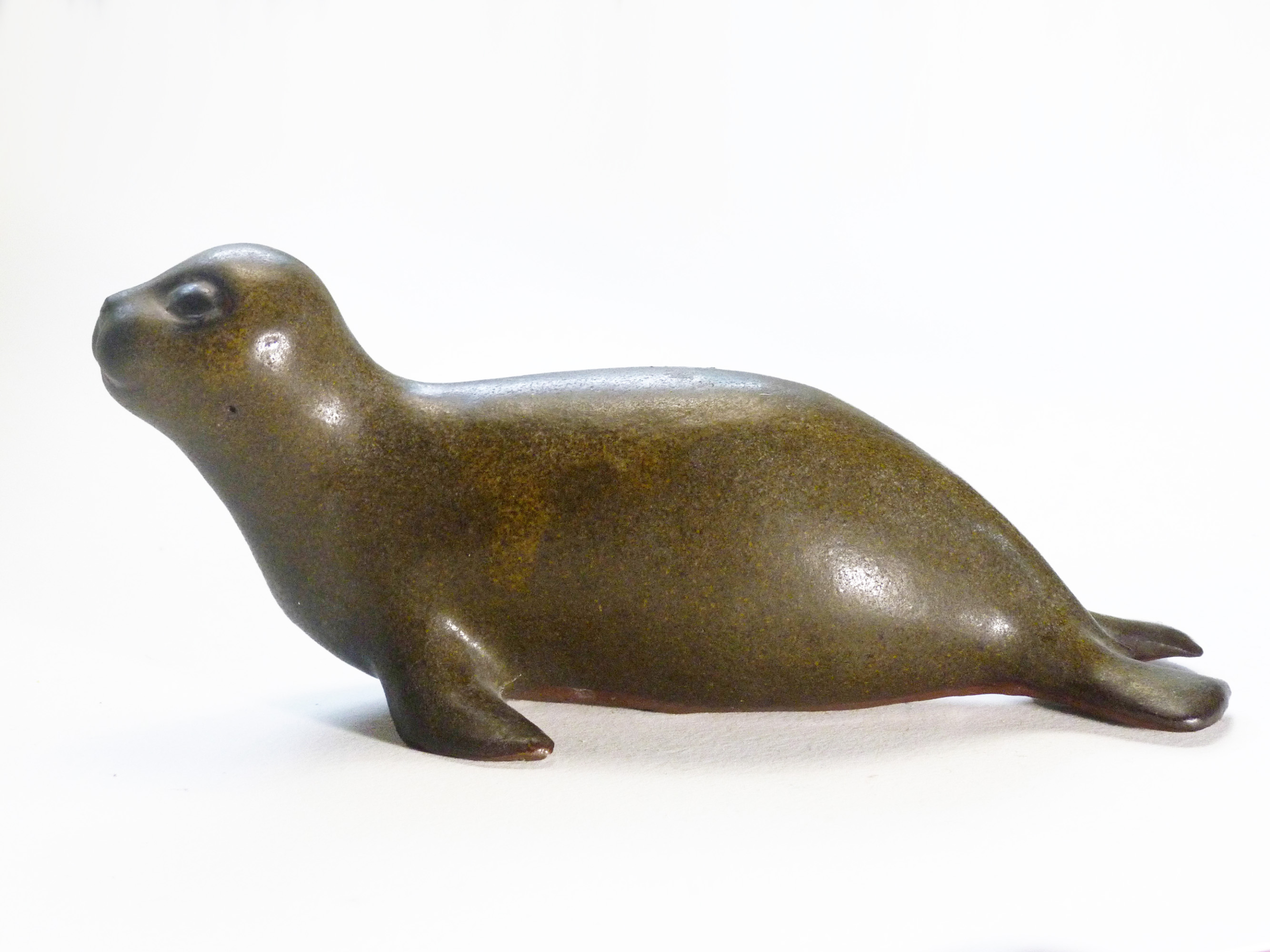 Vintage Baby Seal Early designed by Weston and Brenda Andersen is the early version with wide eyes and short nose., Glazed in rare vintage brown glaze designed by Weston. Eyes ebony. Slip cast in red body. All handcrafted in America, 7 inches long