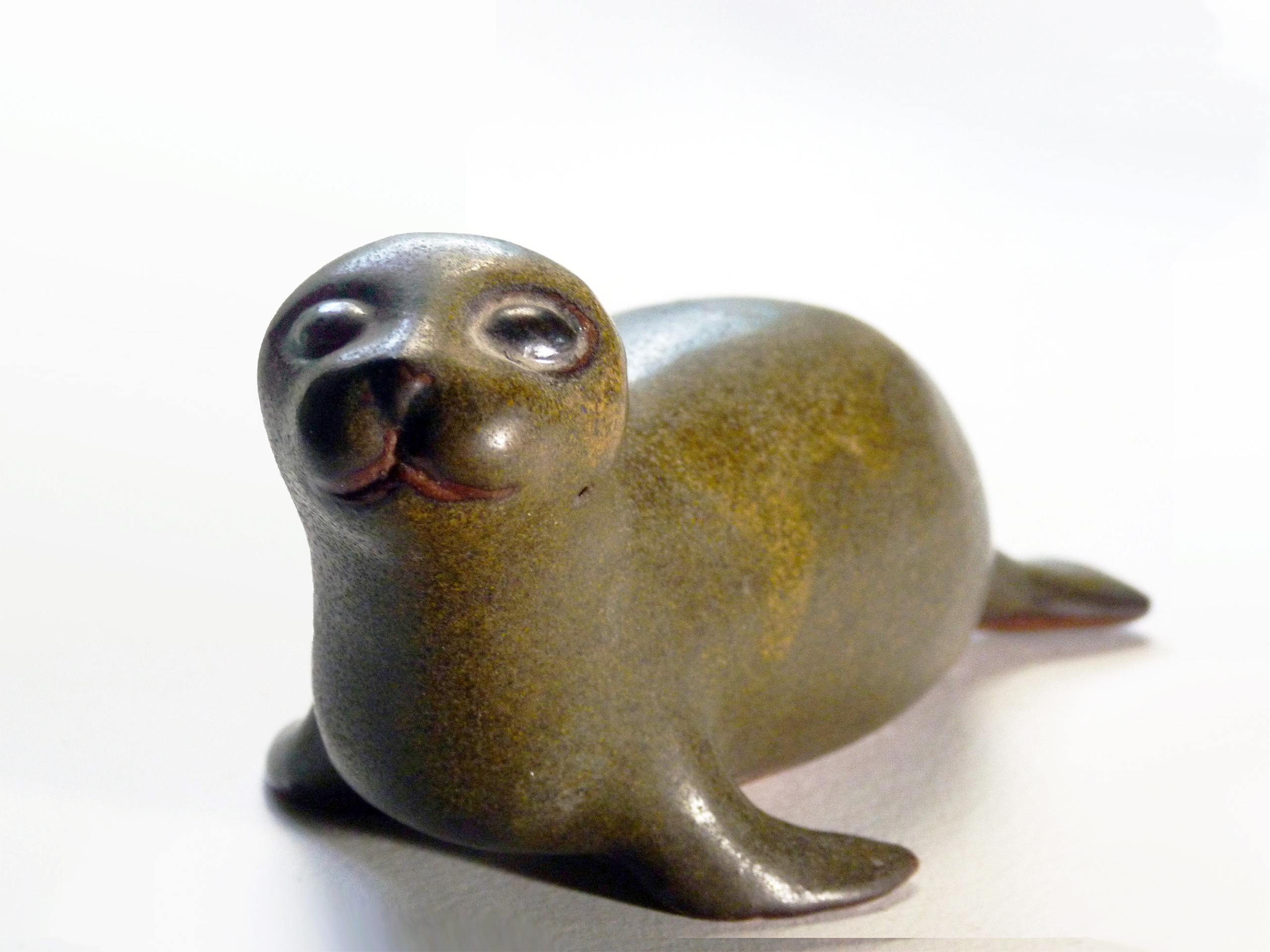 Vintage Baby Seal Early designed by Weston and Brenda Andersen is the early version with wide eyes and short nose., Glazed in rare vintage brown glaze designed by Weston. Eyes ebony. Slip cast in red body. All handcrafted in America, 7 inches long