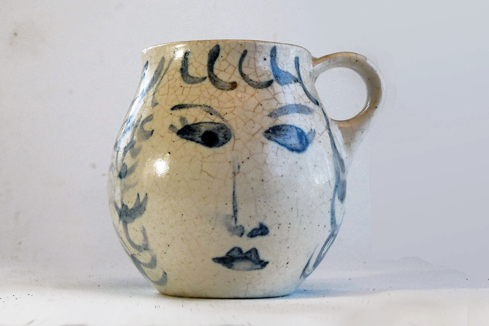 This is a one-of-a-kind mug that is part of a series of seven mugs that Brenda decorated. The mugs are delicately cast. The lip diameter is 2 inches. The body is 3.5 inches tall and wide. Out of this series of mugs, one mug is a portrait of a real person, myself, I call this mug Blue Sweet Sue, because my first name is Susan, and because one side of the mug is blue and the other sweet. I frequently sat alongside my mother when she decorated.