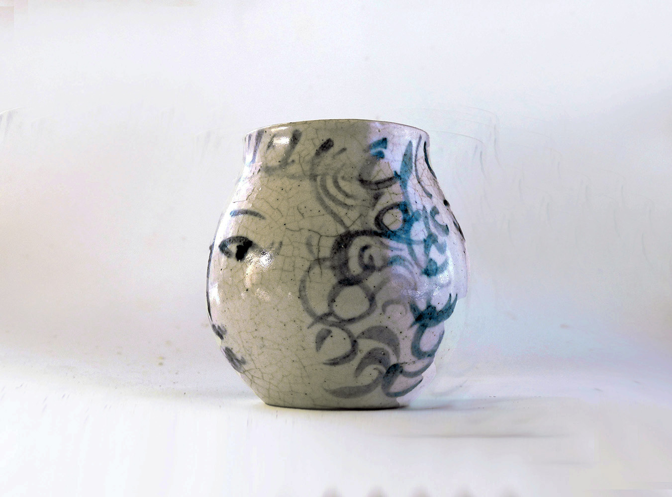 This is a one-of-a-kind mug that is part of a series of seven mugs that Brenda decorated. The mugs are delicately cast. The lip diameter is 2 inches. The body is 3.5 inches tall and wide. Out of this series of mugs, one mug is a portrait of a real person, myself, I call this mug Blue Sweet Sue, because my first name is Susan, and because one side of the mug is blue and the other sweet. I frequently sat alongside my mother when she decorated.