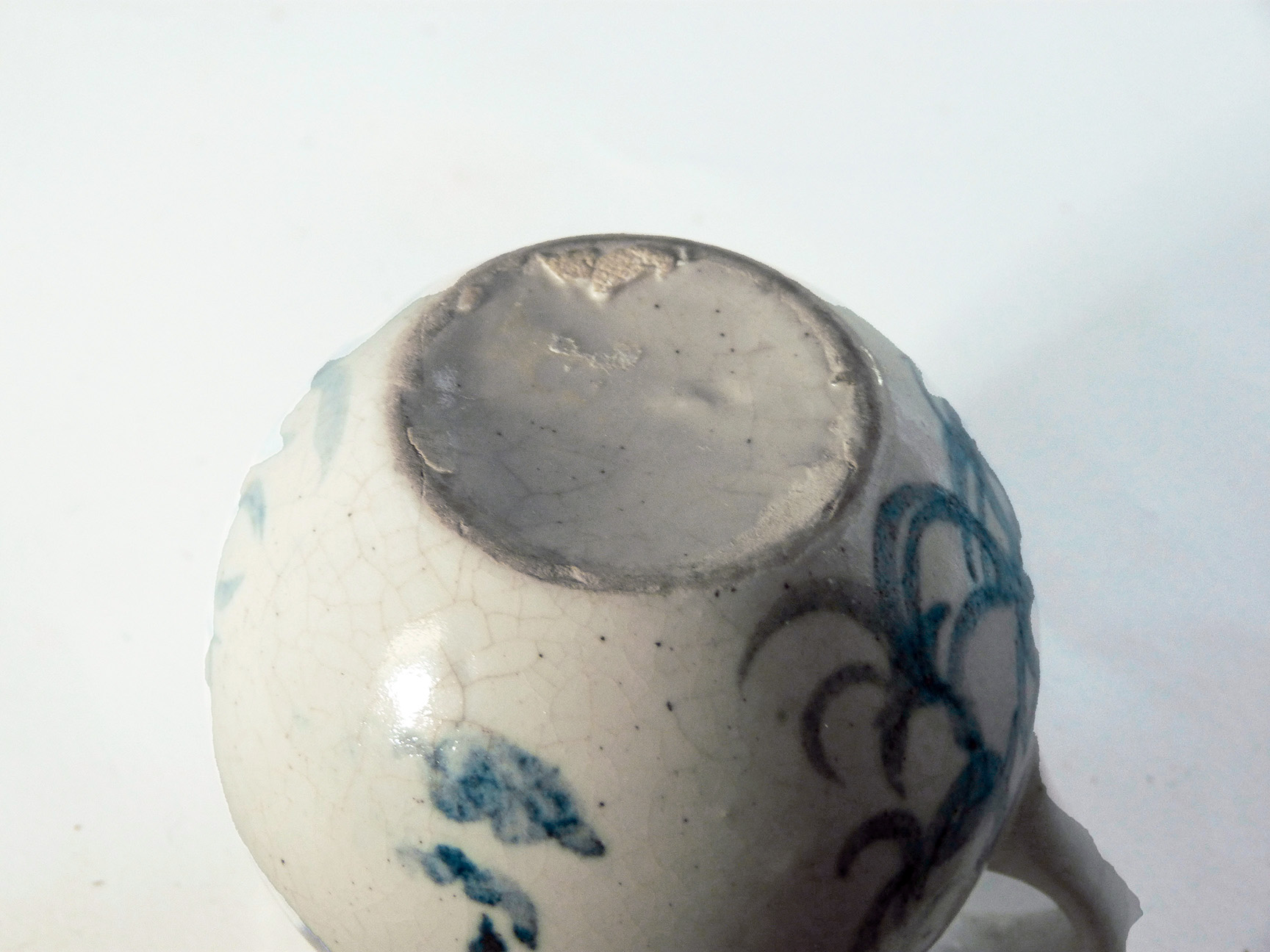 This is a one-of-a-kind mug that is part of a series of seven mugs that Brenda decorated. The mugs are delicately cast. The lip diameter is 2 inches. The body is 3.5 inches tall and wide. Out of this series of mugs, one mug is a portrait of a real person, myself, I call this mug Blue Sweet Sue, because my first name is Susan, and because one side of the mug is blue and the other sweet. I frequently sat alongside my mother when she decorated.