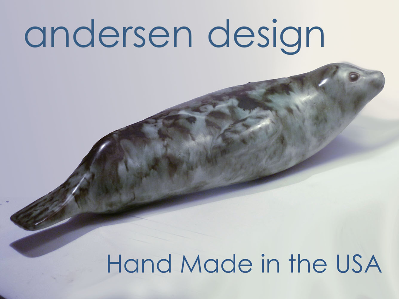 The Antarctic Seal designed by Weston and Brenda Andersen is slip cast in red stoneware, decorated in variegated tones of black and grey and dipped in our white glaze. The eyes are ebony outlined in unembellished red stoneware. The Antarctic Seal is 17 inches long, All hand made in the USA.