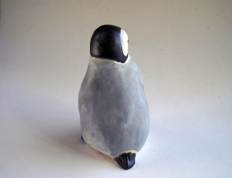 Baby Penguin Sculpture, 5 inches tall, Gray ceramic decorating color flows down the form creating variations in tone. A glossy ebony contrasts with the white matte glaze around the eyes. The Ceramic Baby Penguin is slip-cast in white stoneware and hand-crafted by American artisans,