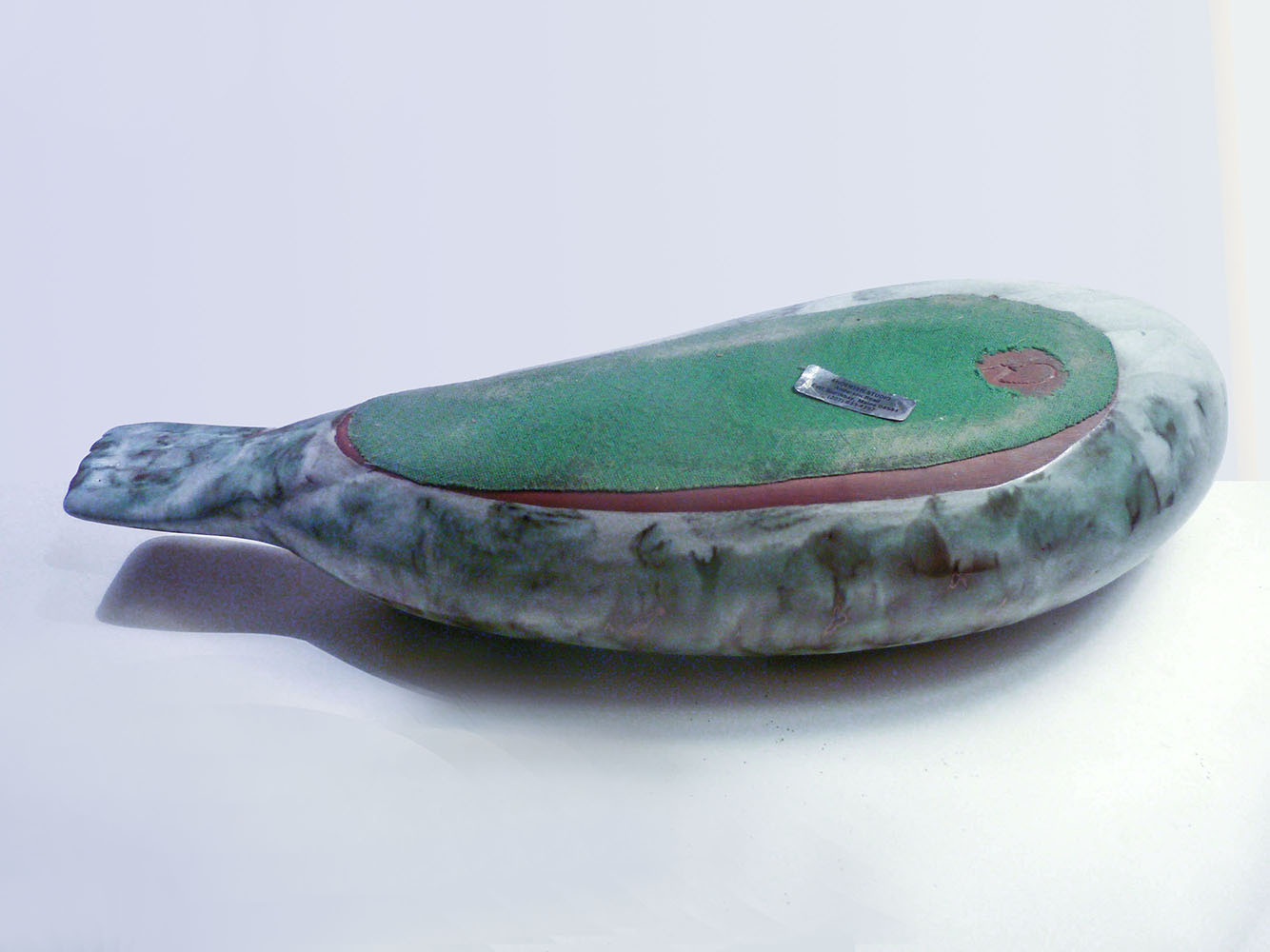 designed by Weston and Brenda Andersen is slip cast in red stoneware, decorated in variegated tones of black and grey and dipped in our white glaze. The eyes are ebony outlined in unembellished red stoneware. The Antarctic Seal is 17 inches long, All hand made in the USA.